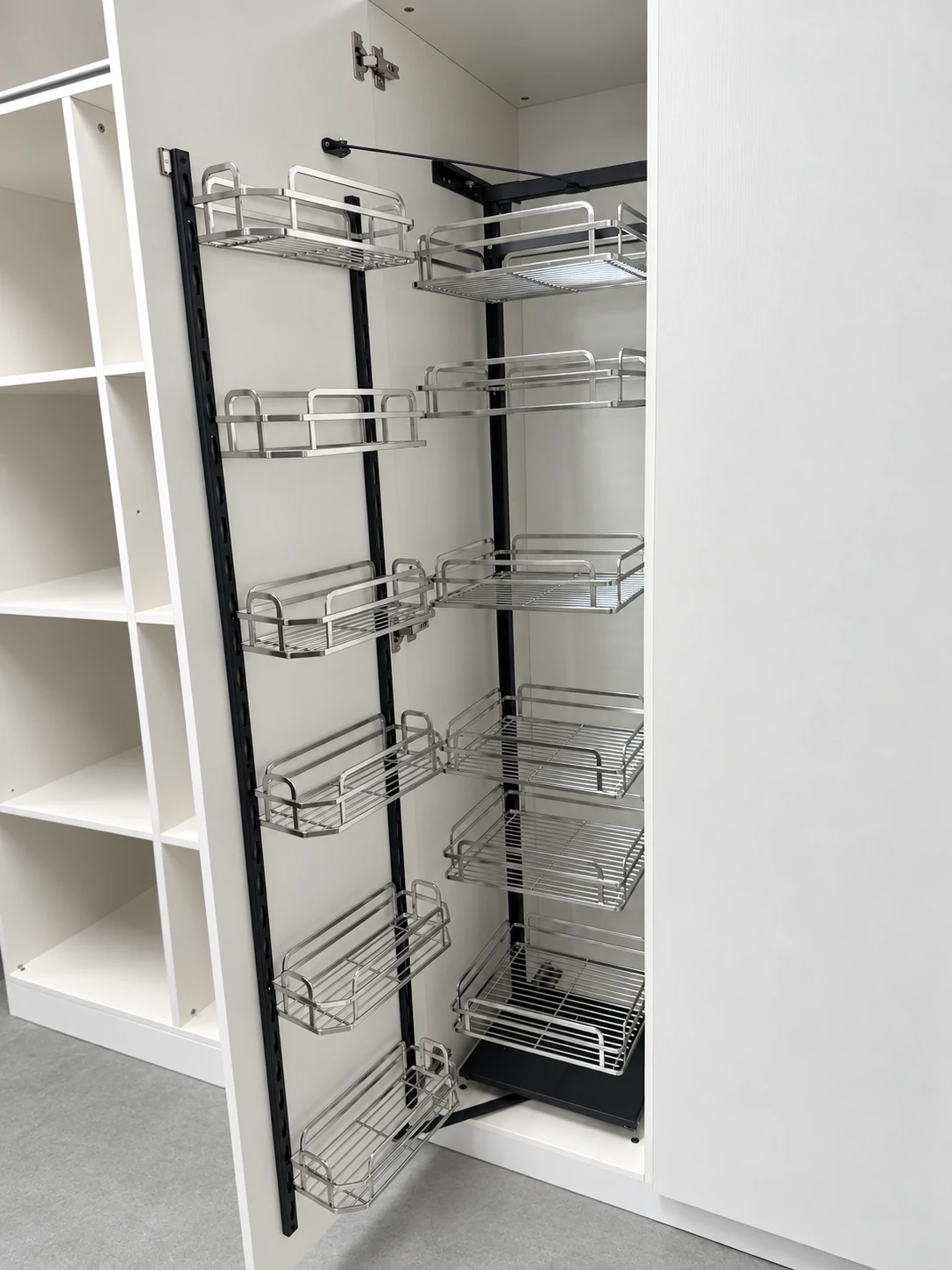 Six tiers of wire baskets on door-side and internal frames in an open pantry cabinet